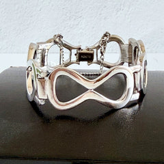 Vintage Monet silver‑tone infinity link bracelet with polished modernist links and signed clasp.