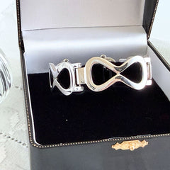 Vintage Monet silver‑tone infinity link bracelet with polished modernist links and signed clasp.