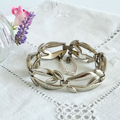 Vintage Monet modernist floral silver‑tone bracelet with sculptural polished links, signed clasp and © Monet hang tag