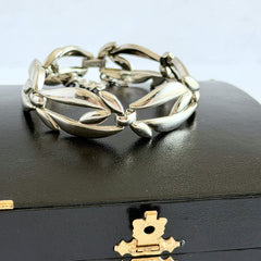 Vintage Monet modernist floral silver‑tone bracelet with sculptural polished links, signed clasp and © Monet hang tag