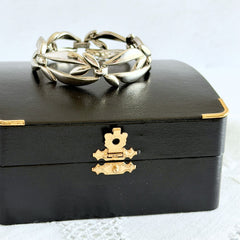 Vintage Monet modernist floral silver‑tone bracelet with sculptural polished links, signed clasp and © Monet hang tag