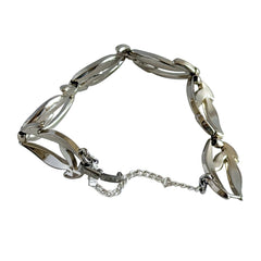 Vintage Monet modernist floral silver‑tone bracelet with sculptural polished links, signed clasp and © Monet hang tag