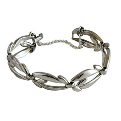 Vintage Monet modernist floral silver‑tone bracelet with sculptural polished links, signed clasp and © Monet hang tag
