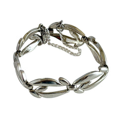 Vintage Monet modernist floral silver‑tone bracelet with sculptural polished links, signed clasp and © Monet hang tag