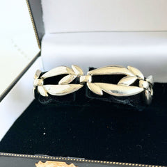 Vintage Monet modernist floral silver‑tone bracelet with sculptural polished links, signed clasp and © Monet hang tag
