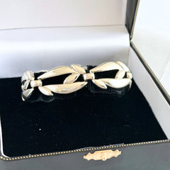 Vintage Monet modernist floral silver‑tone bracelet with sculptural polished links, signed clasp and © Monet hang tag