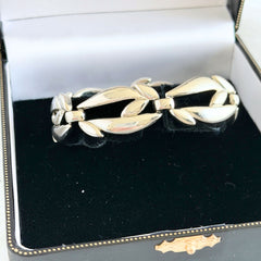Vintage Monet modernist floral silver‑tone bracelet with sculptural polished links, signed clasp and © Monet hang tag
