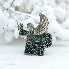 Vintage Monet angel brooch in silver tone metal with teal and light green enamel robe, clear rhinestone wings, and raised star detail; signed Monet on back.