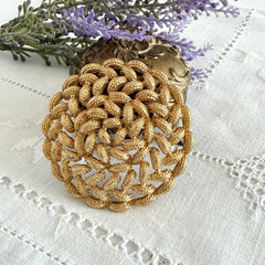 Vintage 1960s Monet braided gold‑tone rope brooch with textured sculptural design. Large 2¼" round statement pin in excellent condition, signed Monet.