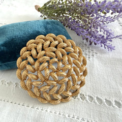 Vintage 1960s Monet braided gold‑tone rope brooch with textured sculptural design. Large 2¼" round statement pin in excellent condition, signed Monet.