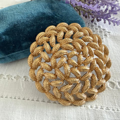 Vintage 1960s Monet braided gold‑tone rope brooch with textured sculptural design. Large 2¼" round statement pin in excellent condition, signed Monet.