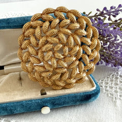 Vintage 1960s Monet braided gold‑tone rope brooch with textured sculptural design. Large 2¼" round statement pin in excellent condition, signed Monet.