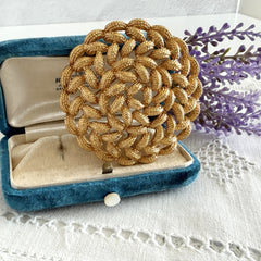 Vintage 1960s Monet braided gold‑tone rope brooch with textured sculptural design. Large 2¼" round statement pin in excellent condition, signed Monet.