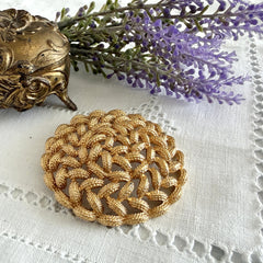 Vintage 1960s Monet braided gold‑tone rope brooch with textured sculptural design. Large 2¼" round statement pin in excellent condition, signed Monet.