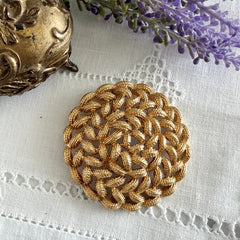Vintage 1960s Monet braided gold‑tone rope brooch with textured sculptural design. Large 2¼" round statement pin in excellent condition, signed Monet.