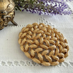 Vintage 1960s Monet braided gold‑tone rope brooch with textured sculptural design. Large 2¼" round statement pin in excellent condition, signed Monet.