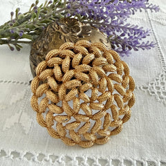 Vintage 1960s Monet braided gold‑tone rope brooch with textured sculptural design. Large 2¼" round statement pin in excellent condition, signed Monet.
