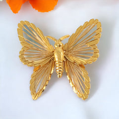 Vintage Monet gold‑tone butterfly brooch with openwork wire wings