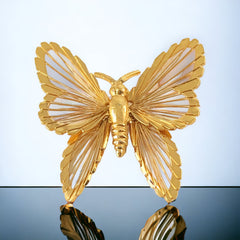 Vintage Monet gold‑tone butterfly brooch with openwork wire wings