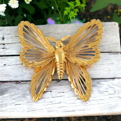 Vintage Monet gold‑tone butterfly brooch with openwork wire wings