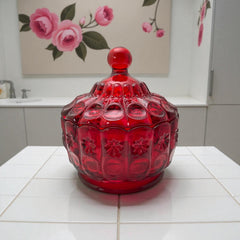 Vintage Moon and Stars ruby red glass candy dish with scalloped bowl and matching lid, featuring embossed celestial motifs and rich translucent color.