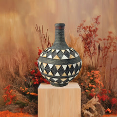 Vintage Moroccan pottery vase from the 1970s/80s, featuring a large clay body with ornate metal inlays, an antiqued bronze/brass finish, and three geometric rings of camel bone triangle patterns. Includes an original metal lid, reflecting its historic use for storing and transporting liquids. In very good vintage condition, showcasing intricate craftsmanship and cultural heritage.