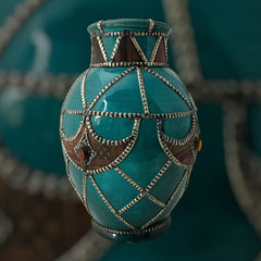 Vintage Moroccan round vase with green glaze, featuring geometric metal decor, four dyed leather inlays with yellow or red bezel-set glass cabochons at their center, and triangle-shaped leather accents around the top, from the 1970s/80s in very good condition.