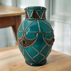 Vintage Moroccan round vase with green glaze, featuring geometric metal decor, four dyed leather inlays with yellow or red bezel-set glass cabochons at their center, and triangle-shaped leather accents around the top, from the 1970s/80s in very good condition.