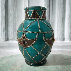 Vintage Moroccan round vase with green glaze, featuring geometric metal decor, four dyed leather inlays with yellow or red bezel-set glass cabochons at their center, and triangle-shaped leather accents around the top, from the 1970s/80s in very good condition.