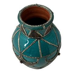 Vintage Moroccan round vase with green glaze, featuring geometric metal decor, four dyed leather inlays with yellow or red bezel-set glass cabochons at their center, and triangle-shaped leather accents around the top, from the 1970s/80s in very good condition.