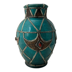 Vintage Moroccan round vase with green glaze, featuring geometric metal decor, four dyed leather inlays with yellow or red bezel-set glass cabochons at their center, and triangle-shaped leather accents around the top, from the 1970s/80s in very good condition.