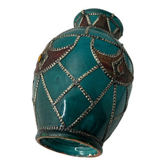 Vintage Moroccan round vase with green glaze, featuring geometric metal decor, four dyed leather inlays with yellow or red bezel-set glass cabochons at their center, and triangle-shaped leather accents around the top, from the 1970s/80s in very good condition.