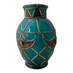 Vintage Moroccan round vase with green glaze, featuring geometric metal decor, four dyed leather inlays with yellow or red bezel-set glass cabochons at their center, and triangle-shaped leather accents around the top, from the 1970s/80s in very good condition.
