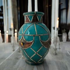 Vintage Moroccan round vase with green glaze, featuring geometric metal decor, four dyed leather inlays with yellow or red bezel-set glass cabochons at their center, and triangle-shaped leather accents around the top, from the 1970s/80s in very good condition.