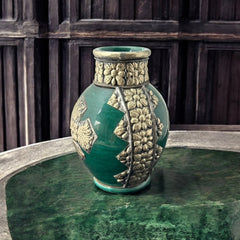 Vintage Moroccan small vase from the 1970s or 1980s, featuring a green glaze with ornate metal overlay in floral and geometric patterns, very good condition.