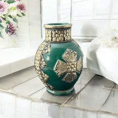 Vintage Moroccan small vase from the 1970s or 1980s, featuring a green glaze with ornate metal overlay in floral and geometric patterns, very good condition.