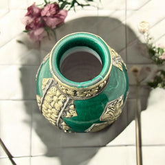 Vintage Moroccan small vase from the 1970s or 1980s, featuring a green glaze with ornate metal overlay in floral and geometric patterns, very good condition.