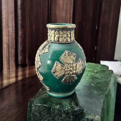 Vintage Moroccan small vase from the 1970s or 1980s, featuring a green glaze with ornate metal overlay in floral and geometric patterns, very good condition.