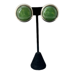 Vintage French button earrings featuring moss green marbled plastic cabochons set in silver tone borders. A classy and elegant 1970s design with retro charm, perfect for sustainable and eco-conscious fashion lovers.
