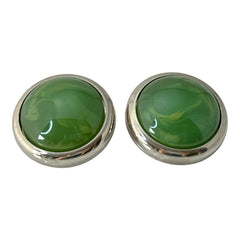 Vintage French button earrings featuring moss green marbled plastic cabochons set in silver tone borders. A classy and elegant 1970s design with retro charm, perfect for sustainable and eco-conscious fashion lovers.