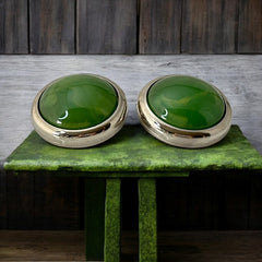 Vintage French button earrings featuring moss green marbled plastic cabochons set in silver tone borders. A classy and elegant 1970s design with retro charm, perfect for sustainable and eco-conscious fashion lovers.