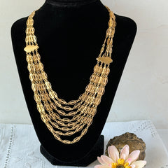 Vintage multi‑strand filigree gold‑tone bib necklace with ornate oval links and adjustable hook clasp.