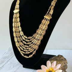 Vintage multi‑strand filigree gold‑tone bib necklace with ornate oval links and adjustable hook clasp.