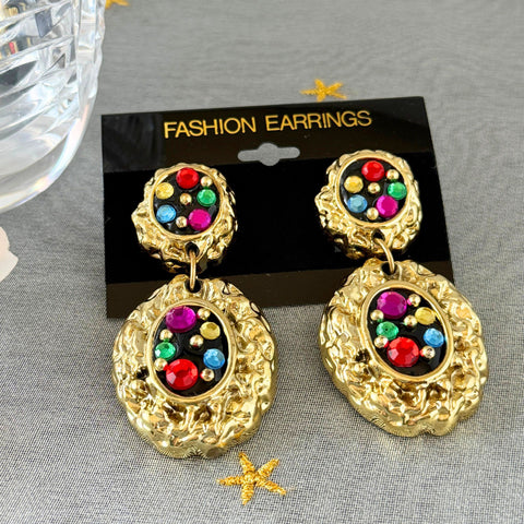 Vintage 1980s multicolor rhinestone black enamel textured gold‑tone clip‑on earrings on original Fashion Earrings card, front and back views.
