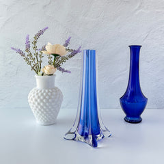 Vintage cobalt blue and clear glass vase with sculptural pulled base and triangular rim, shown from multiple angles.
