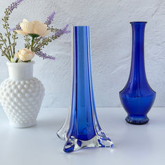 Vintage cobalt blue and clear glass vase with sculptural pulled base and triangular rim, shown from multiple angles.