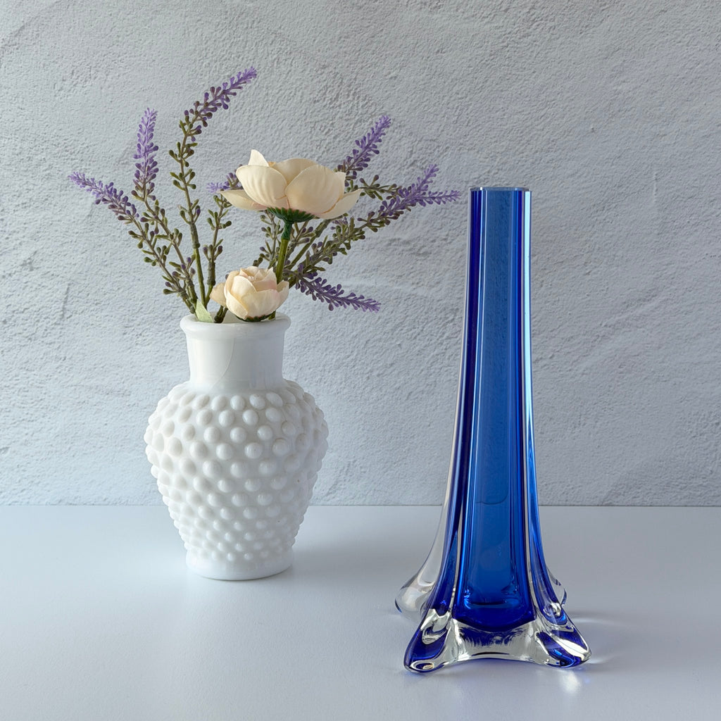 Vintage cobalt blue and clear glass vase with sculptural pulled base and triangular rim, shown from multiple angles.