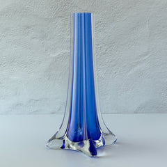 Vintage cobalt blue and clear glass vase with sculptural pulled base and triangular rim, shown from multiple angles.