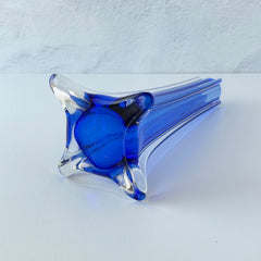 Vintage cobalt blue and clear glass vase with sculptural pulled base and triangular rim, shown from multiple angles.
