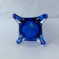 Vintage cobalt blue and clear glass vase with sculptural pulled base and triangular rim, shown from multiple angles.